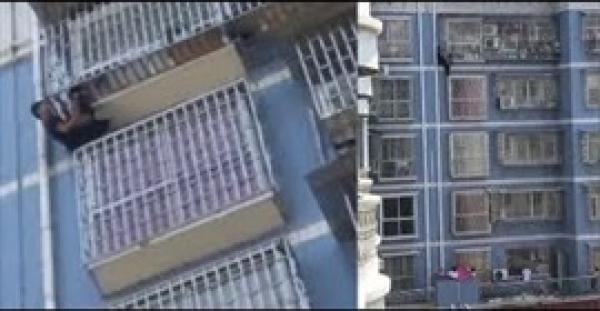 رجل يتسلق 5 طوابق لإنقاذ طفل يتدلى من نافذة (فيديو)